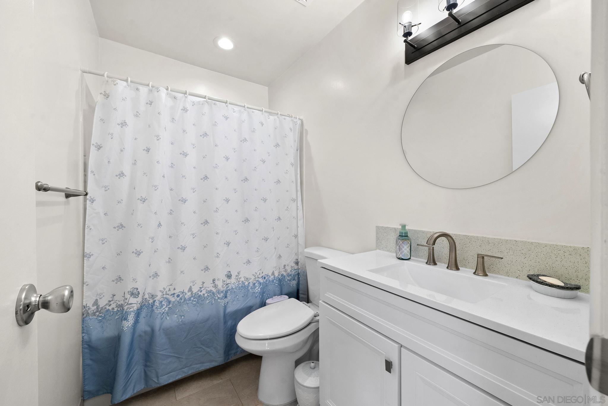 1407 5 D Drive El Cajon, CA 92021 - Photo 20 of 37 a bathroom with a sink a toilet and a mirror
