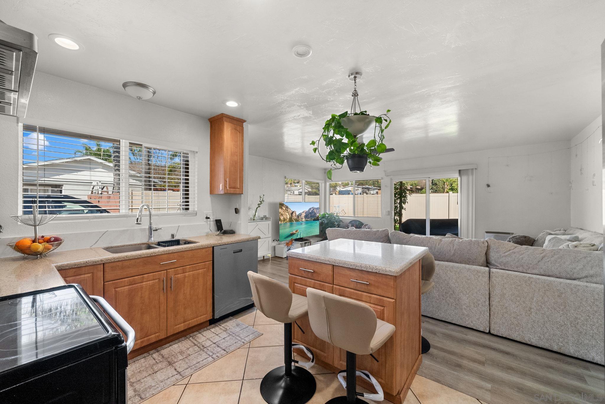 1407 5 D Drive El Cajon, CA 92021 - Photo 30 of 37 a living room with kitchen island furniture and a chandelier