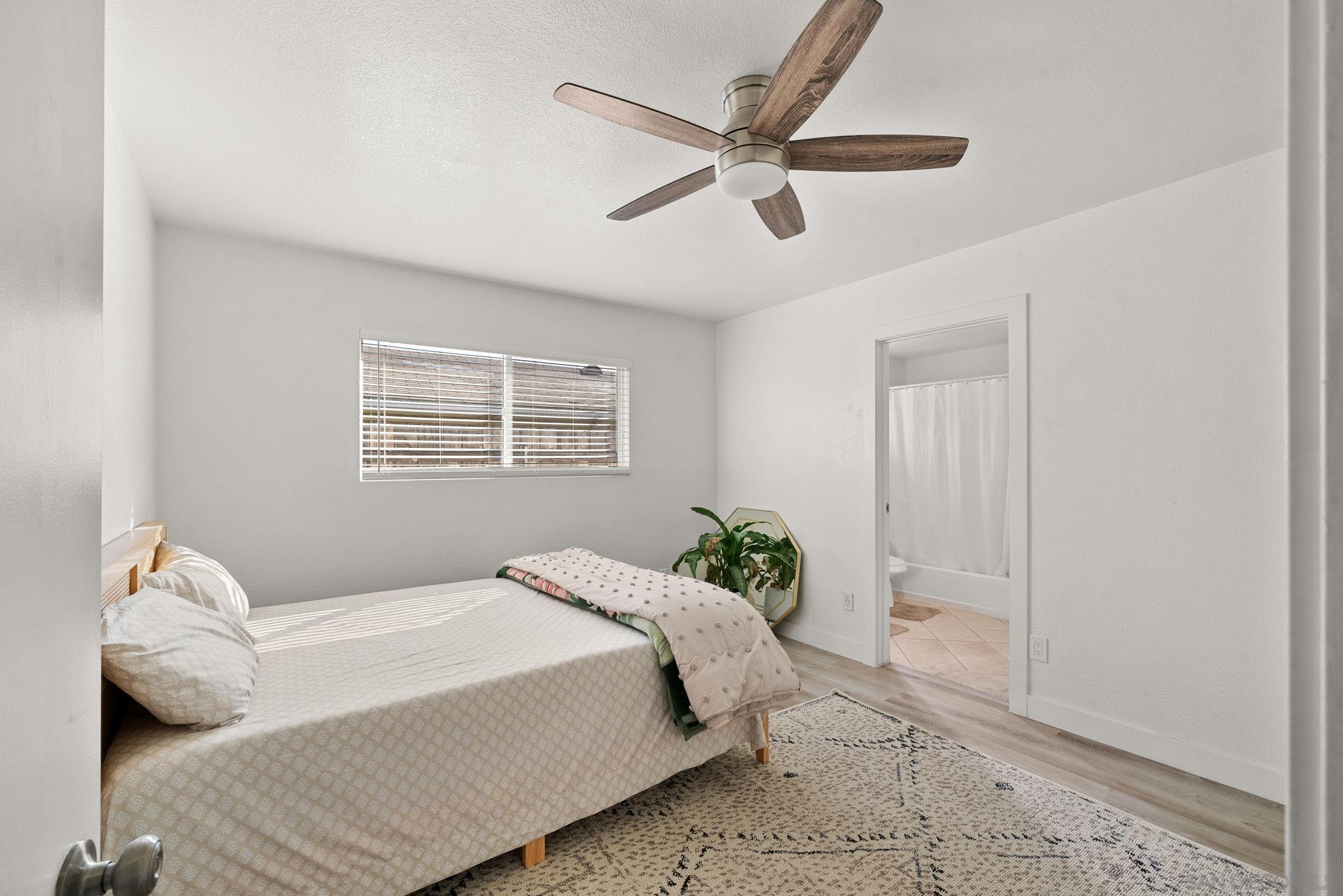 1407 5 D Drive El Cajon, CA 92021 - Photo 33 of 37 a bedroom with a large bed and a window