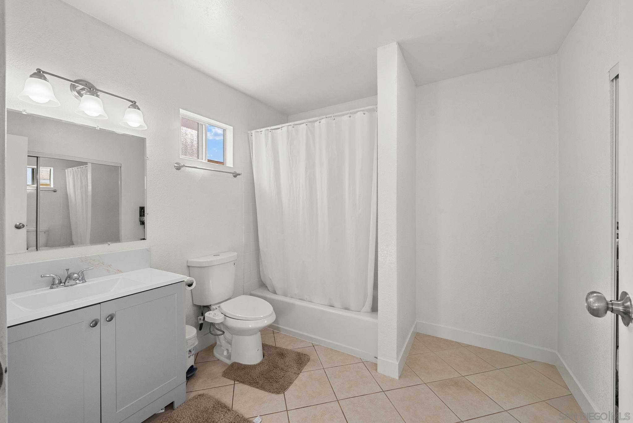 1407 5 D Drive El Cajon, CA 92021 - Photo 34 of 37 a bathroom with a toilet sink and a mirror