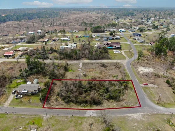 an aerial view of a residential houses with outdoor space