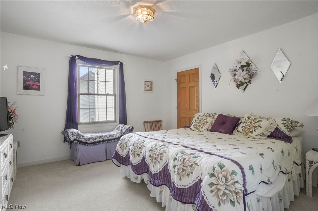 693 Timbercreek Road Northfield, OH 44067 - Photo 14 of 34 Upstairs Bedroom featuring light carpet