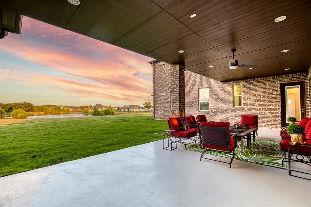 901 Inverness Court Lucas, TX 75002 - Photo 4 of 40 Patio terrace at dusk featuring a ceiling fan, a patio, a lawn, and outdoor lounge area