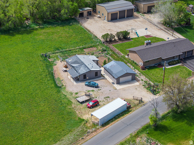 94 Spring Canyon Road Coalville, UT 84017 - Photo 3 of 50 Expansive property featuring multiple structures including a main residence, a detached two-car garage, a large three-door workshop, and an additional storage shed