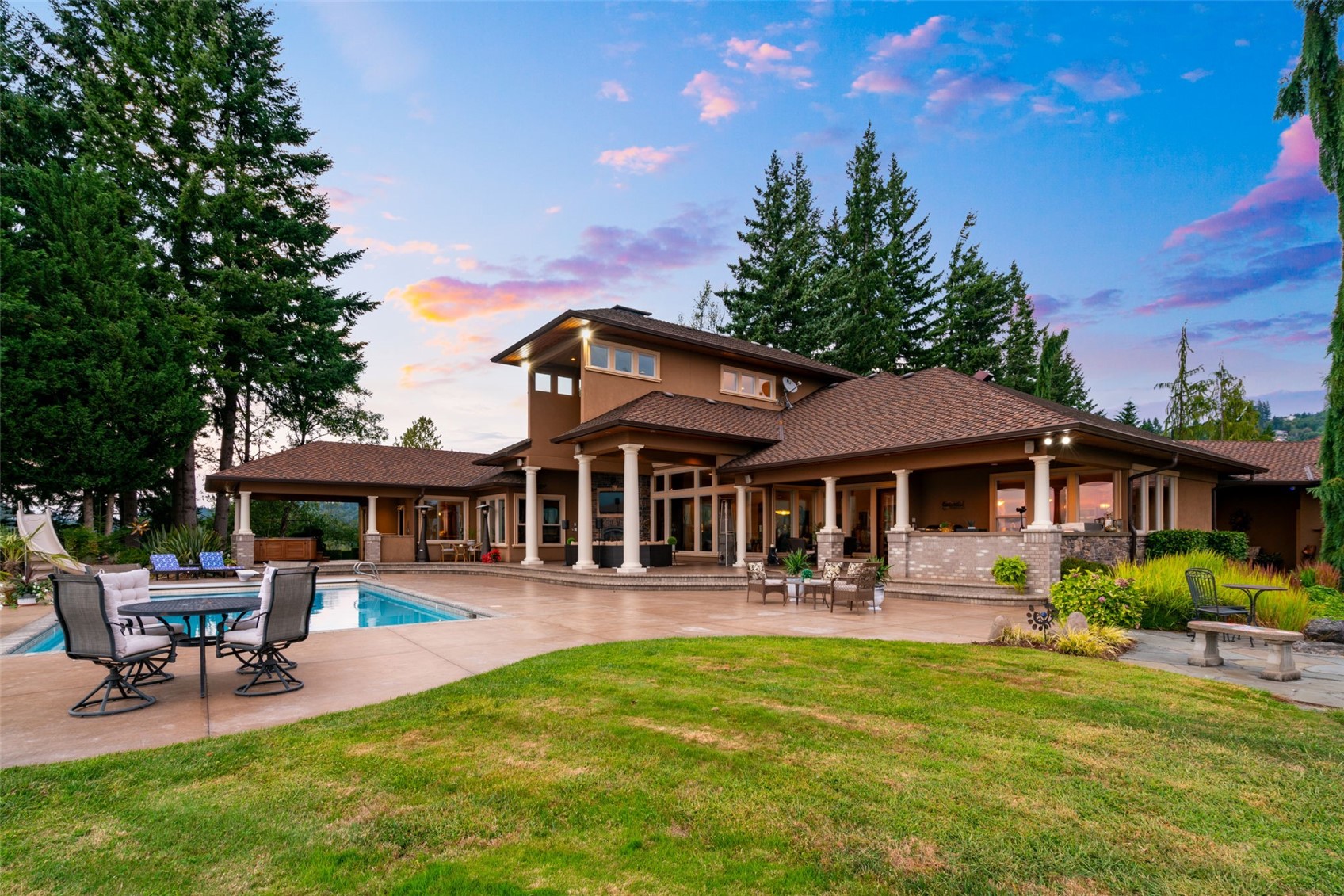 a front view of a house with garden and sitting area