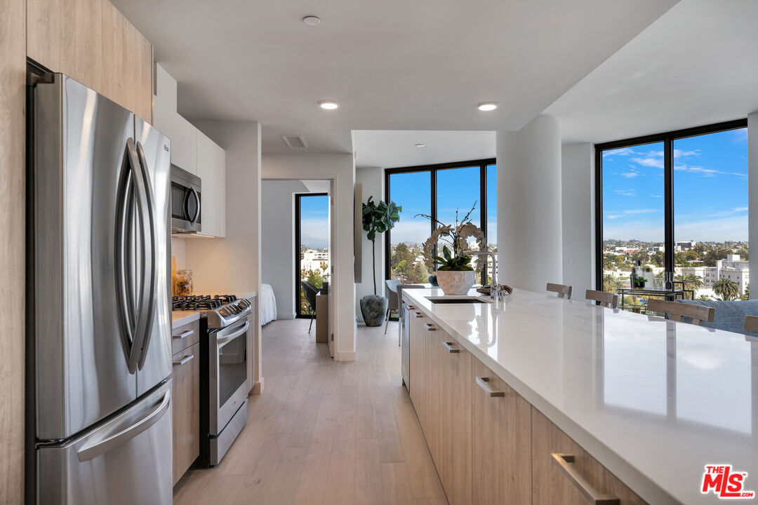 2801 Sunset Place, Unit 626 Los Angeles, CA 90005 - Photo 2 of 18 a kitchen with stainless steel appliances a refrigerator sink and stove