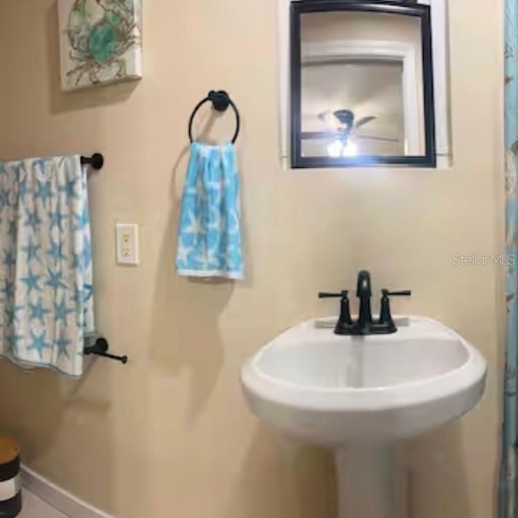 870 South McCall Road, Unit 4 Englewood, FL 34223 - Photo 7 of 7 a bathroom with a sink and mirror