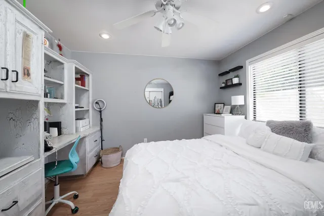 a bedroom with a bed furniture and a large window