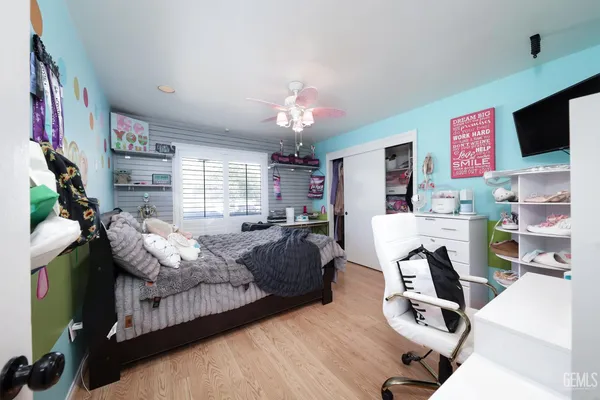 a bedroom with furniture a flat screen tv and a fireplace