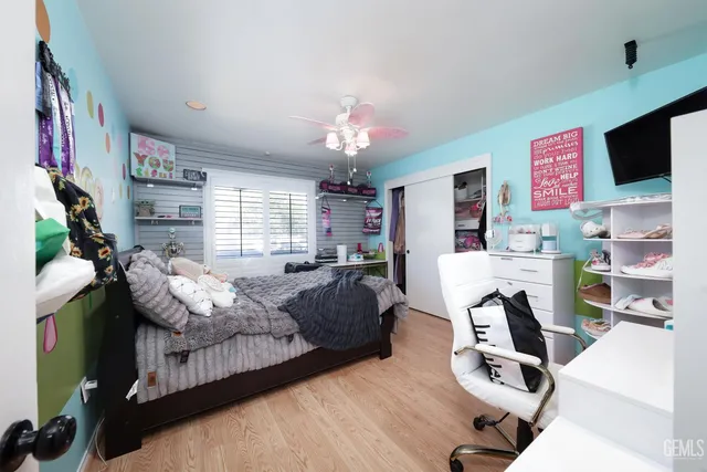 a bedroom with furniture a flat screen tv and a fireplace