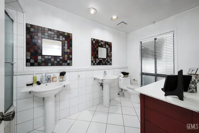 a bathroom with a sink mirror and a bathtub