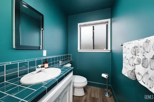 a bathroom with a sink toilet and mirror