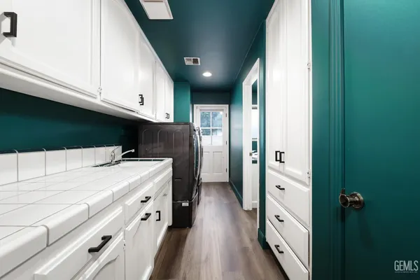 a kitchen with stainless steel appliances a refrigerator and a cabinets