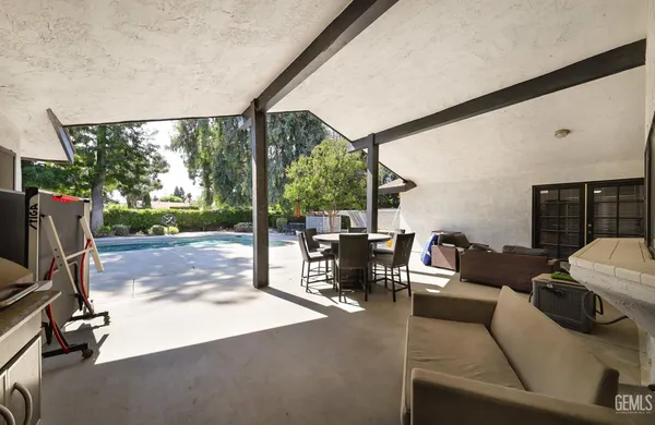 a living room with patio furniture and garden view