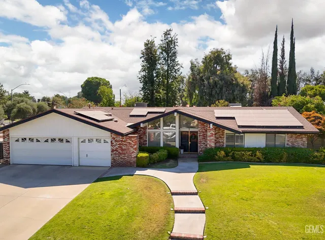 a front view of a house with a yard table and chairs