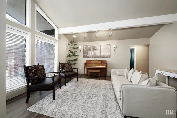a living room with furniture and a piano