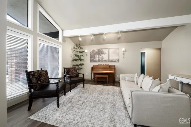 a living room with furniture and a piano