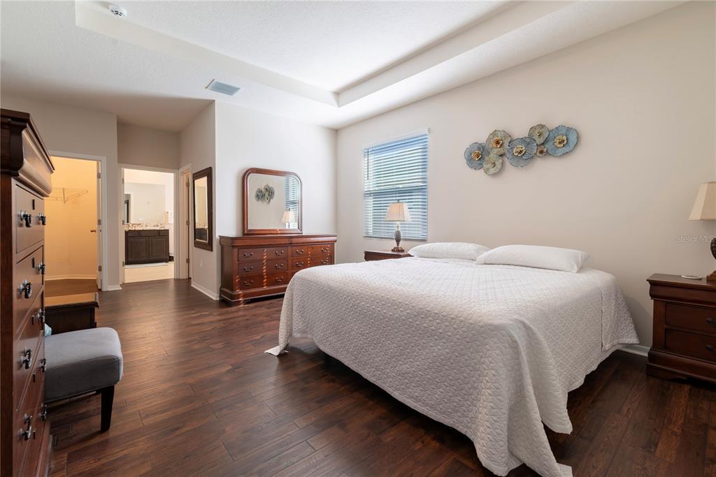 8284 Southwest 59th Terrace Ocala, FL 34476 - Photo 16 of 63 a spacious bedroom with a bed and a couch