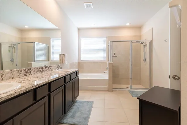 a bathroom with a granite countertop shower