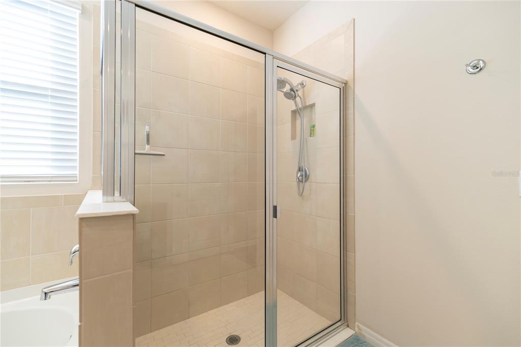 8284 Southwest 59th Terrace Ocala, FL 34476 - Photo 20 of 63 a bathroom with a shower and a glass door