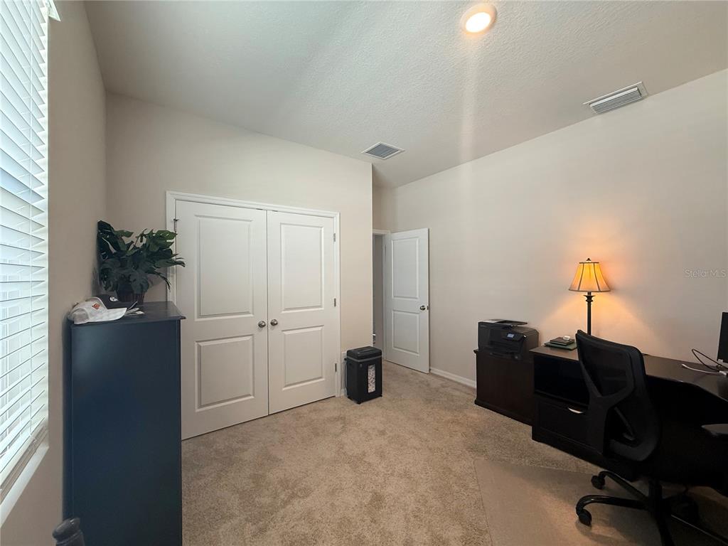 8284 Southwest 59th Terrace Ocala, FL 34476 - Photo 24 of 63 a view of a workspace with furniture and a window