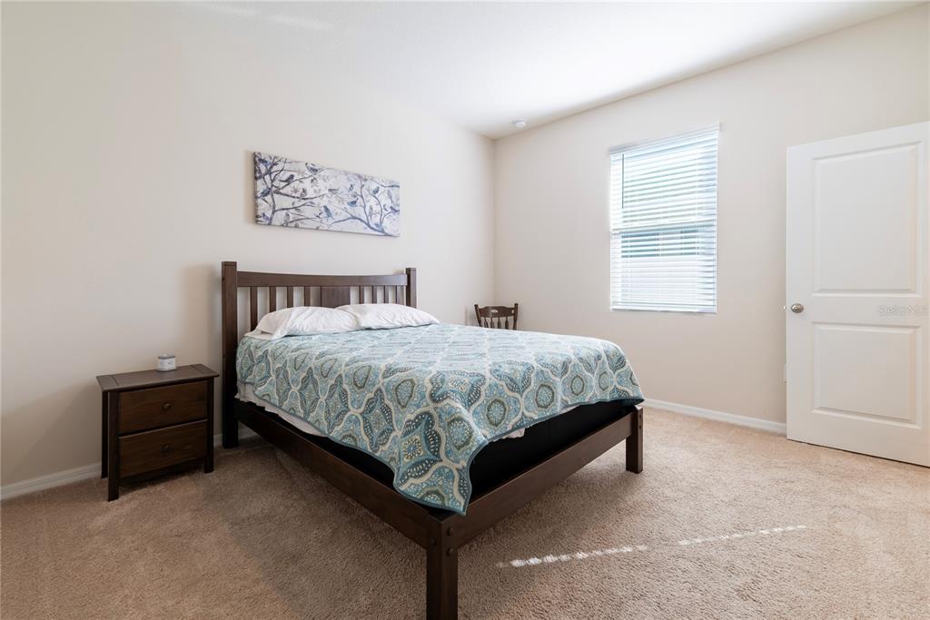 8284 Southwest 59th Terrace Ocala, FL 34476 - Photo 27 of 63 a bed sitting in a bedroom next to a window