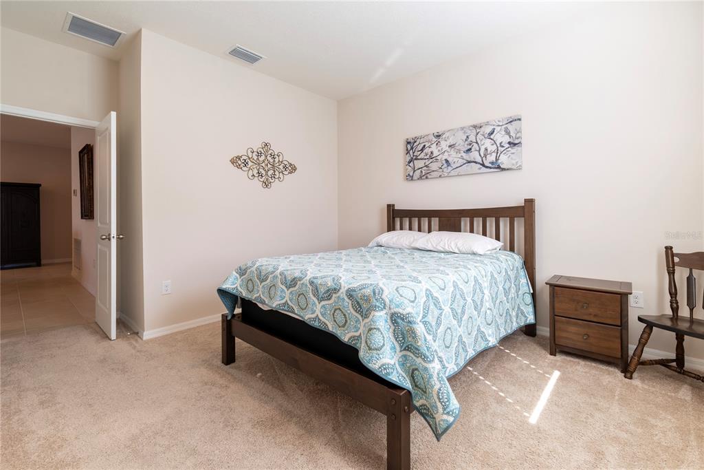 8284 Southwest 59th Terrace Ocala, FL 34476 - Photo 28 of 63 a bedroom with a bed and a table in it