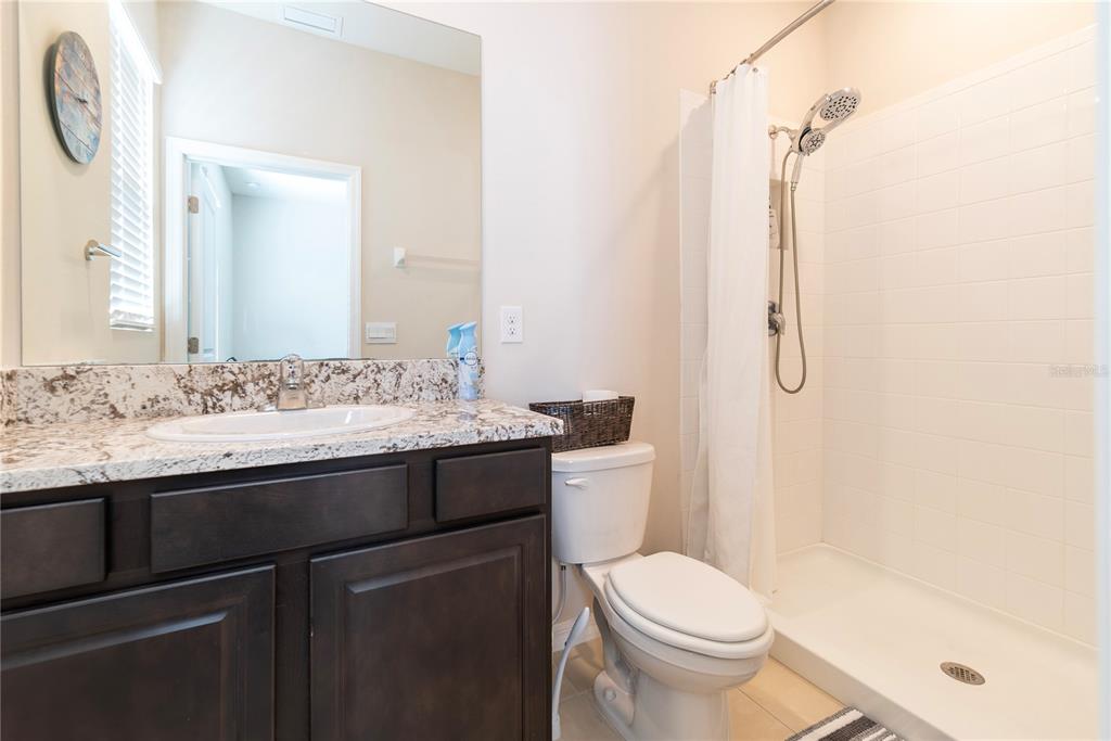 8284 Southwest 59th Terrace Ocala, FL 34476 - Photo 29 of 63 a bathroom with a granite countertop sink toilet and shower