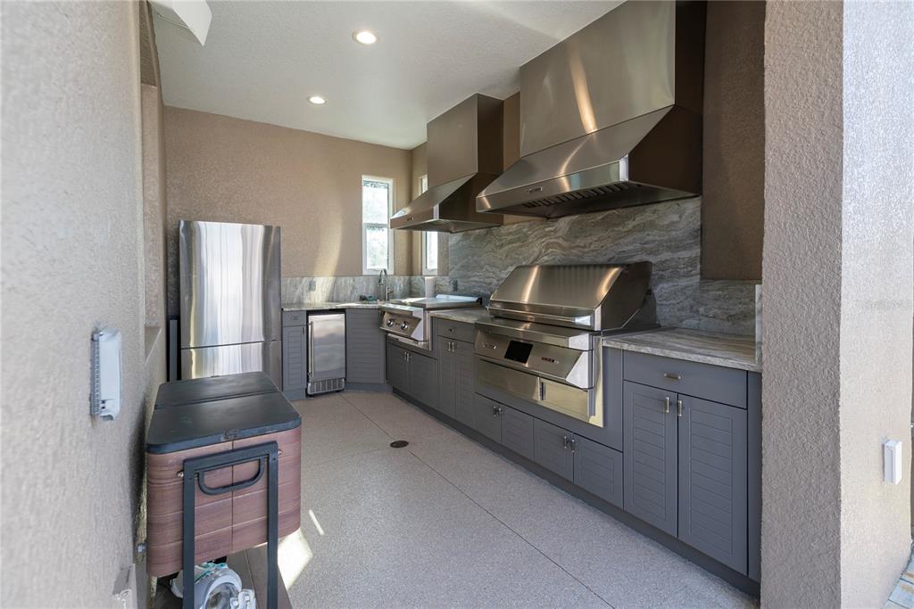 8284 Southwest 59th Terrace Ocala, FL 34476 - Photo 3 of 63 a kitchen with stainless steel appliances granite countertop a stove a sink and a refrigerator