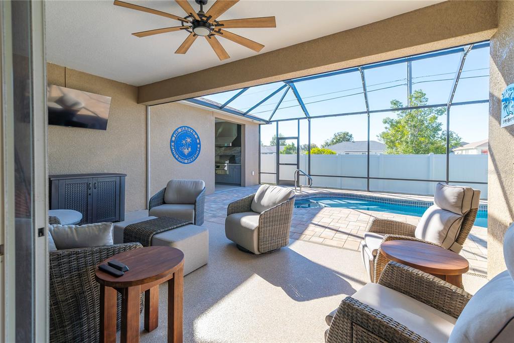8284 Southwest 59th Terrace Ocala, FL 34476 - Photo 34 of 63 a living room with furniture and a floor to ceiling window