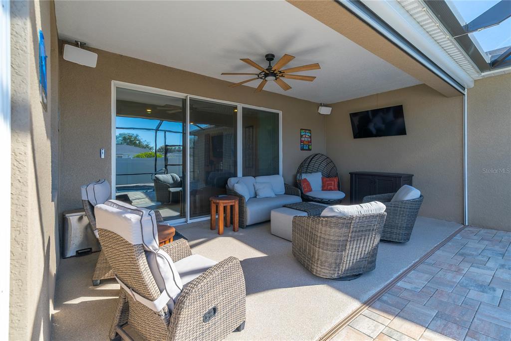 8284 Southwest 59th Terrace Ocala, FL 34476 - Photo 35 of 63 a living room with furniture a floor to ceiling window and a flat screen tv