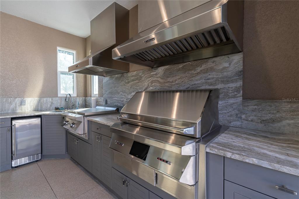 8284 Southwest 59th Terrace Ocala, FL 34476 - Photo 40 of 63 a kitchen with a stove and white cabinets