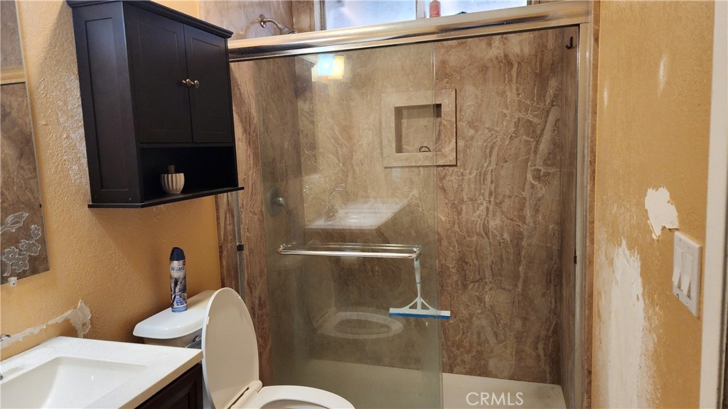 18133 10th Street Bloomington, CA 92316 - Photo 12 of 15 a bathroom with a shower and a toilet