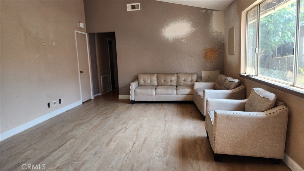 18133 10th Street Bloomington, CA 92316 - Photo 2 of 15 a living room with furniture and a large window