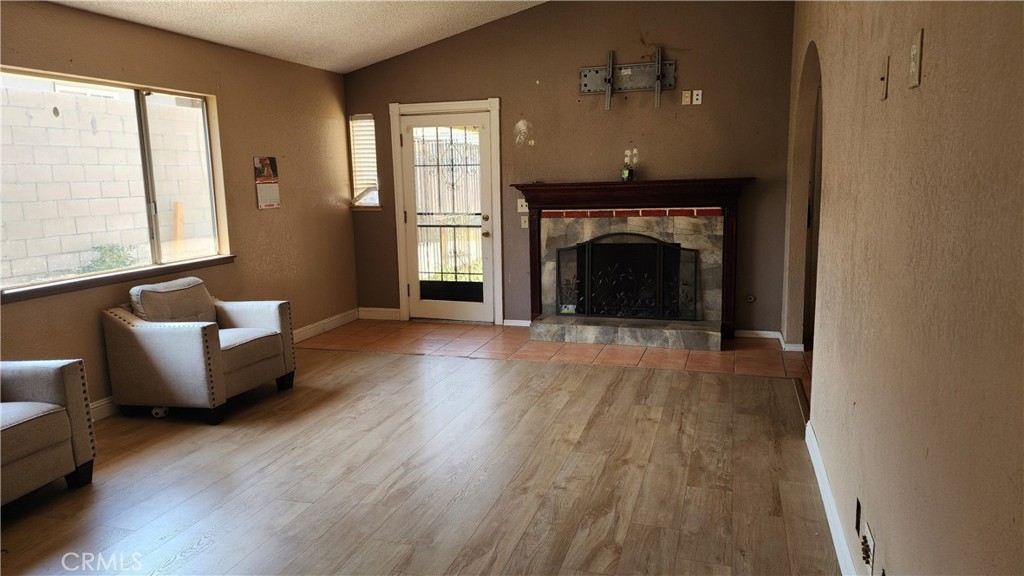 18133 10th Street Bloomington, CA 92316 - Photo 3 of 15 a living room with furniture and a fireplace