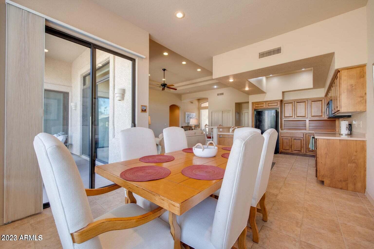 25603 North Sago Drive Rio Verde, AZ 85263 - Photo 6 of 25 a dining room with furniture and a floor to ceiling window