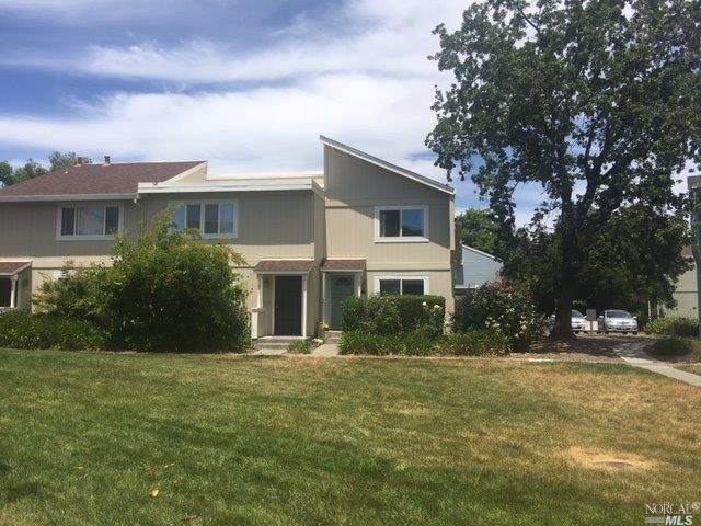 a front view of house with yard and trees