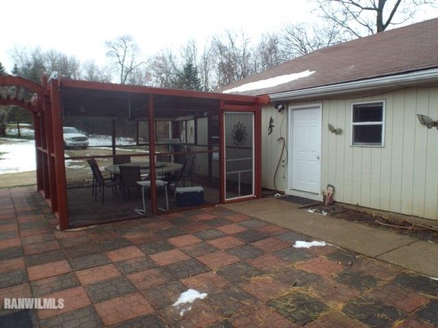 8011 Haas Road Savanna, IL 61074 - Photo 18 of 36 a view of a patio with table and chairs and wooden fence