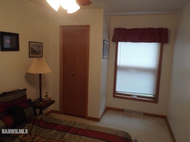 8011 Haas Road Savanna, IL 61074 - Photo 8 of 36 a view of an empty room with wooden floor and a window