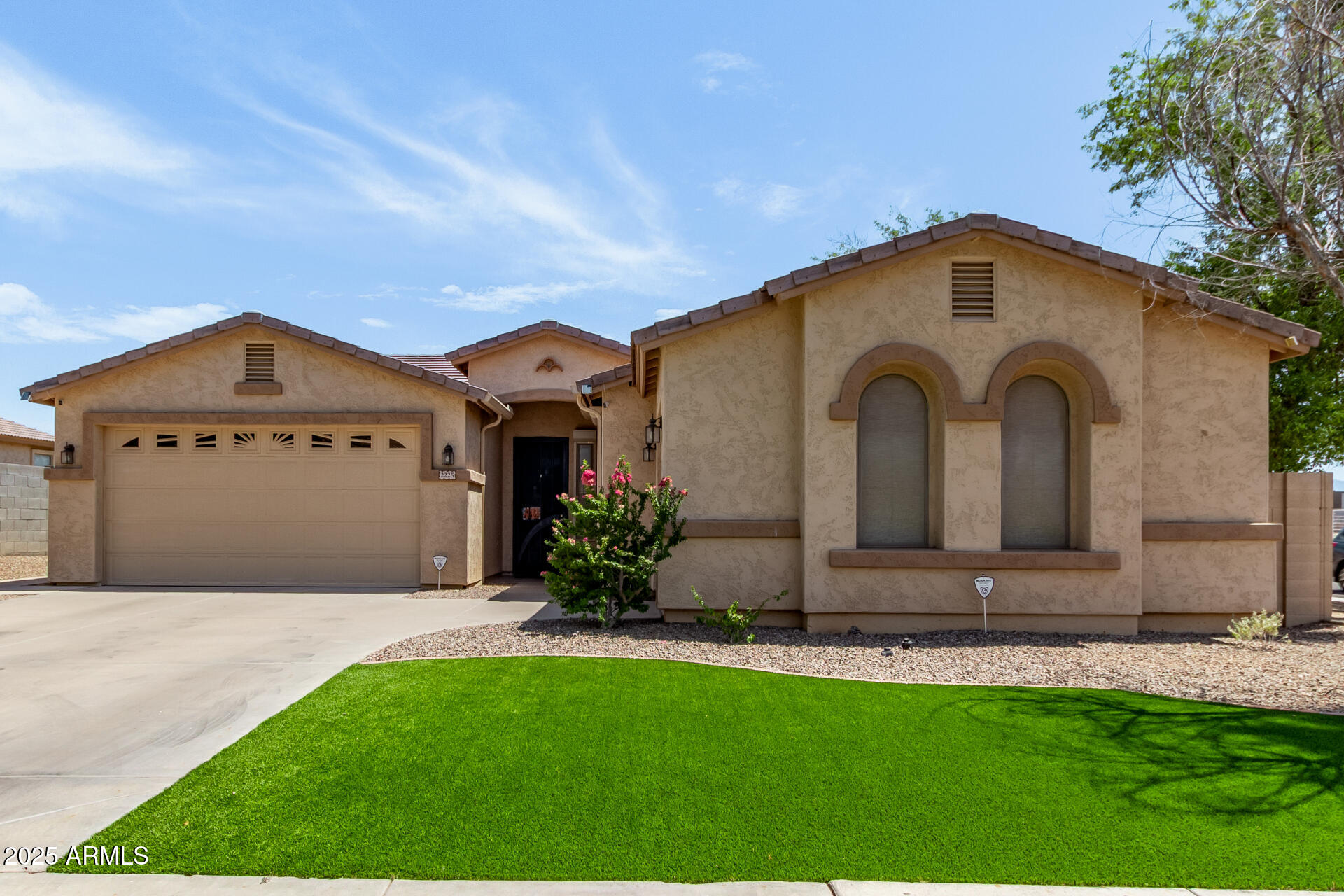 2225 West Carter Road Phoenix, AZ 85041 - Photo 1 of 33 a view of a grey house with a yard and large tree