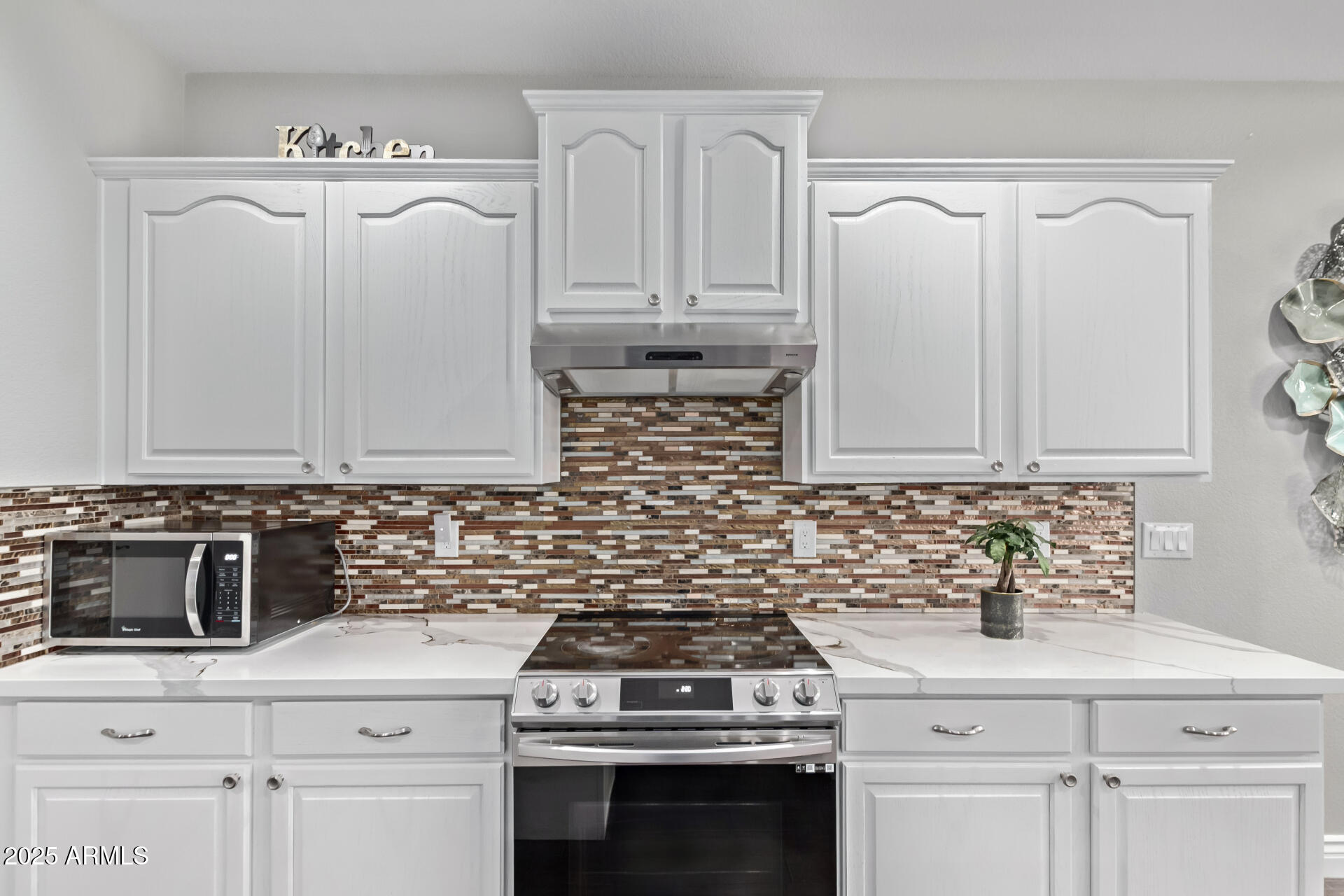 2225 West Carter Road Phoenix, AZ 85041 - Photo 14 of 33 a kitchen with white cabinets and white appliances