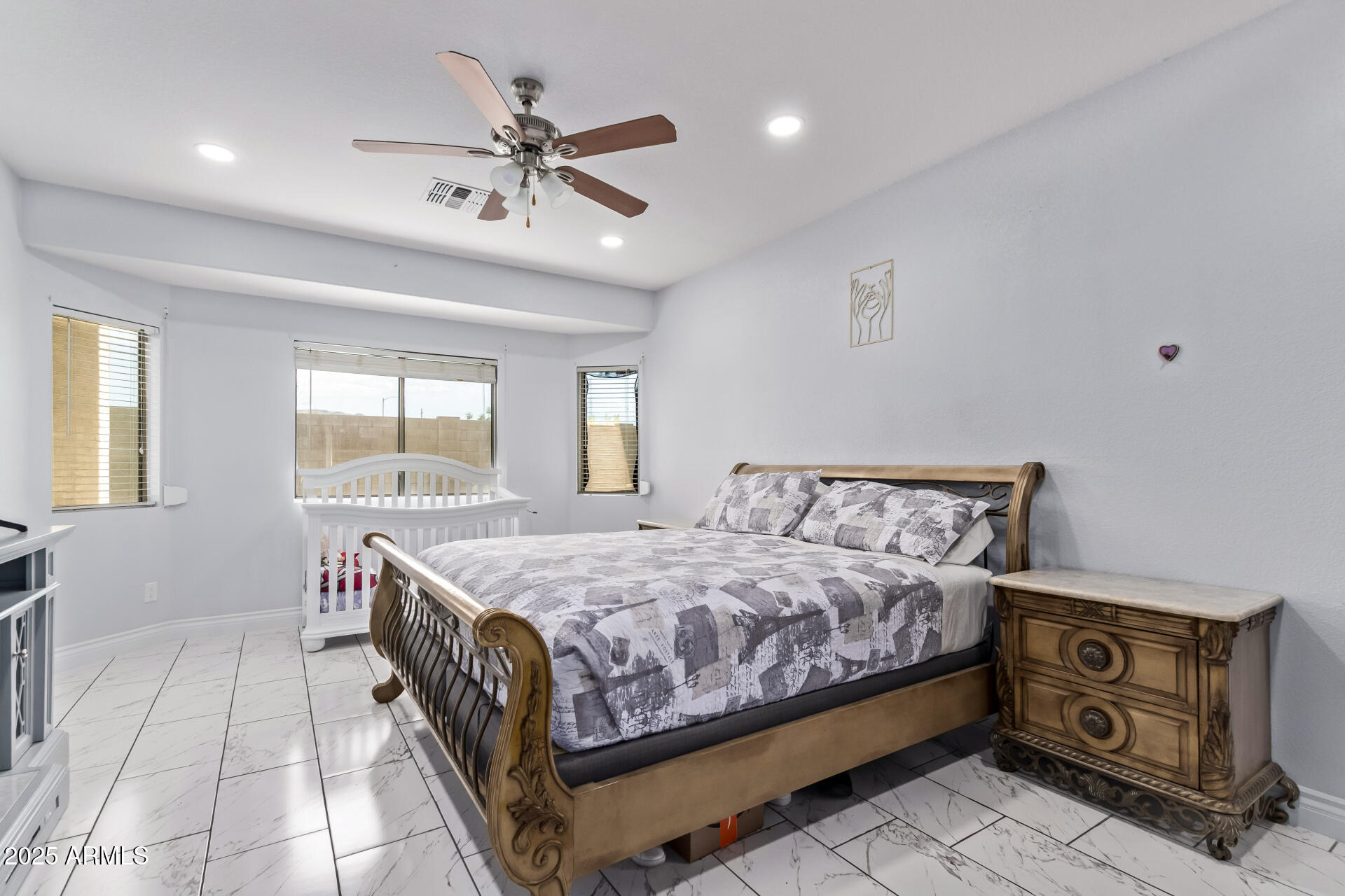 2225 West Carter Road Phoenix, AZ 85041 - Photo 15 of 33 a bedroom with a bed a chandelier and a dresser