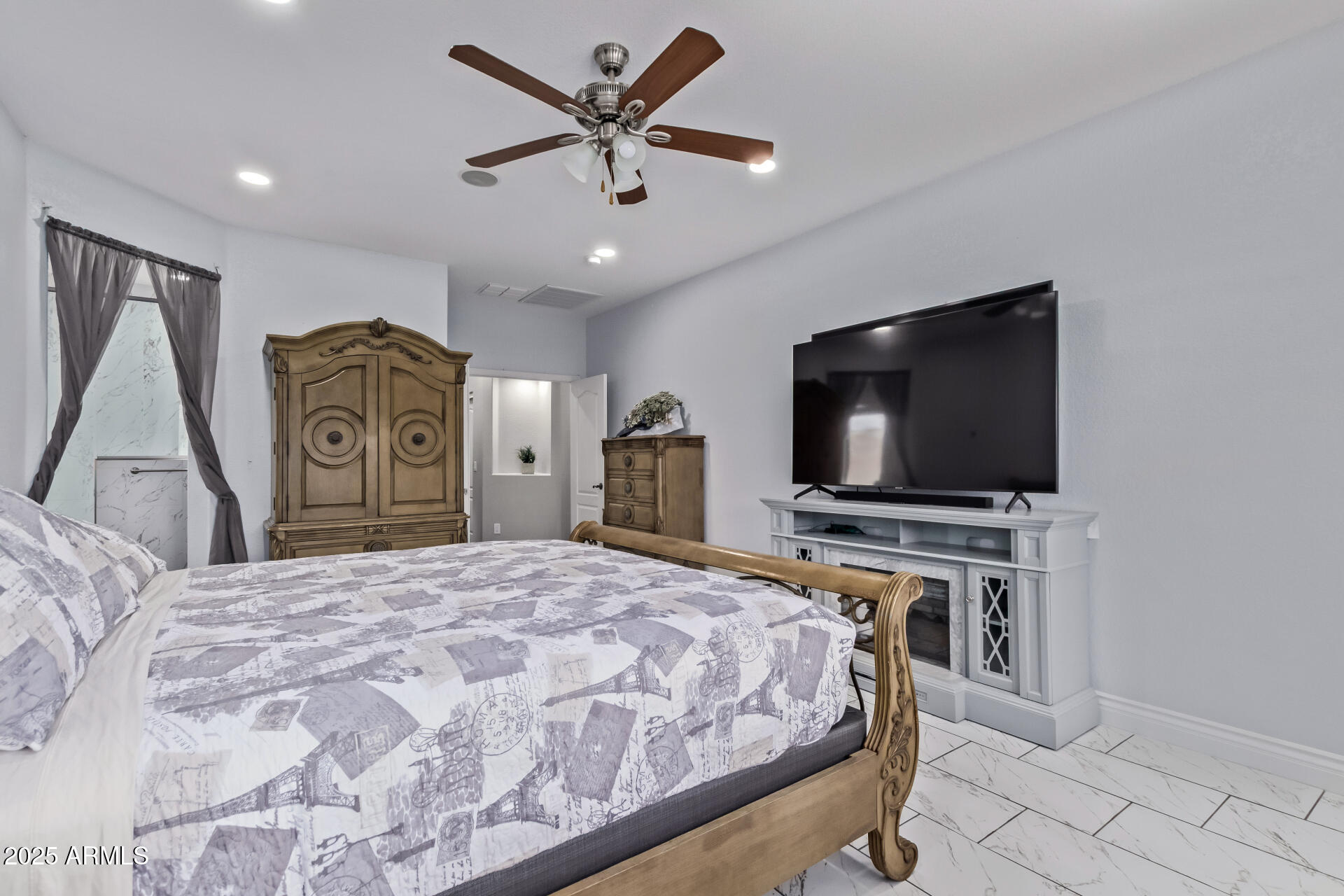 2225 West Carter Road Phoenix, AZ 85041 - Photo 16 of 33 a bedroom with a bed and a flat screen tv