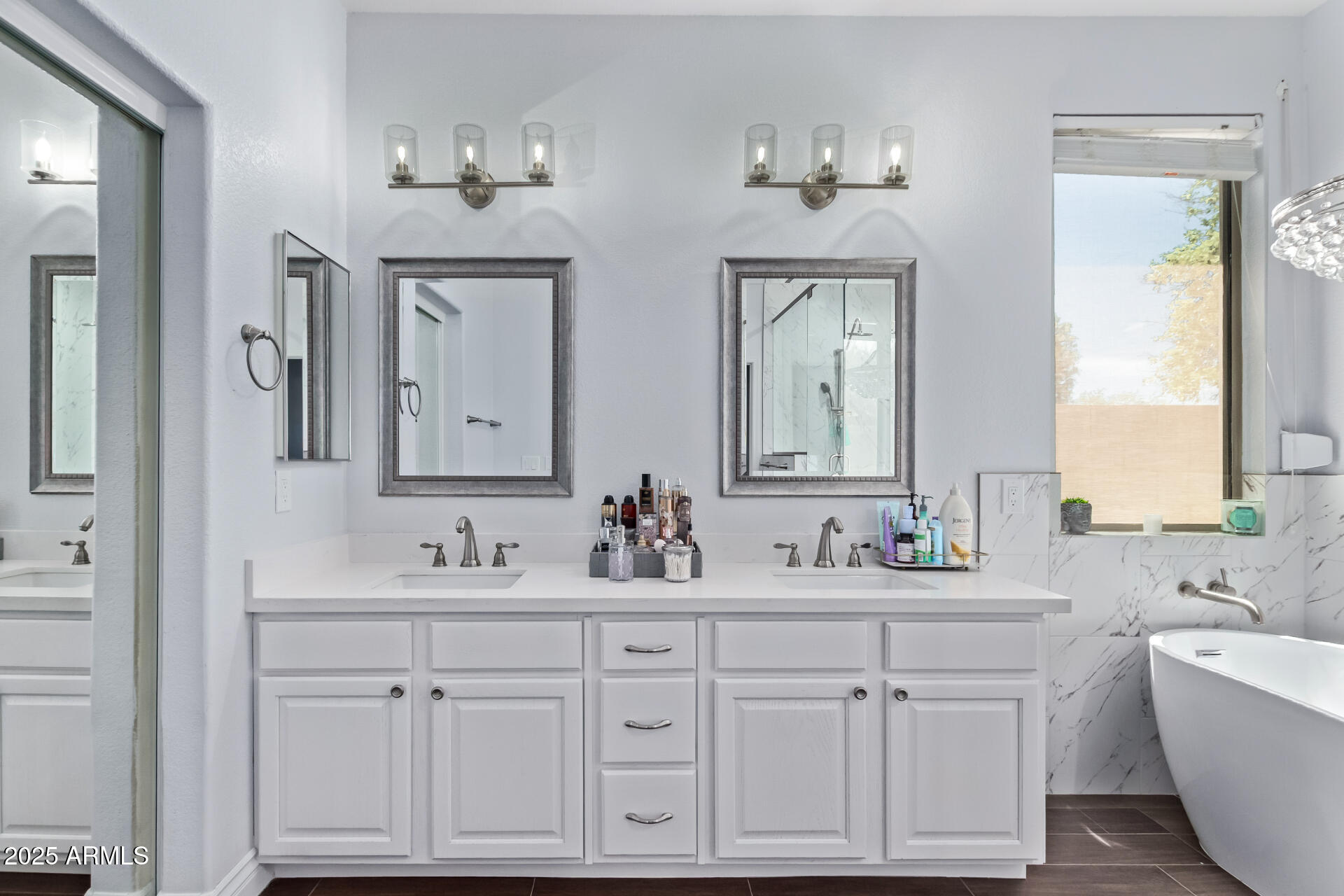 2225 West Carter Road Phoenix, AZ 85041 - Photo 19 of 33 a bathroom with double vanity sinks a toilet a mirror and window