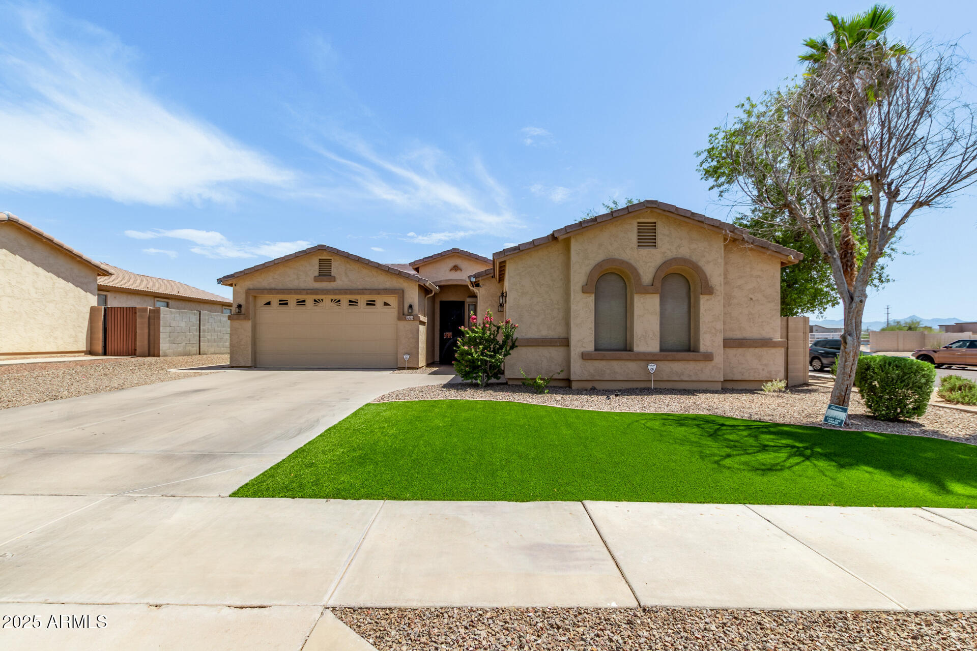 2225 West Carter Road Phoenix, AZ 85041 - Photo 2 of 33 a front view of a house with a yard and garage