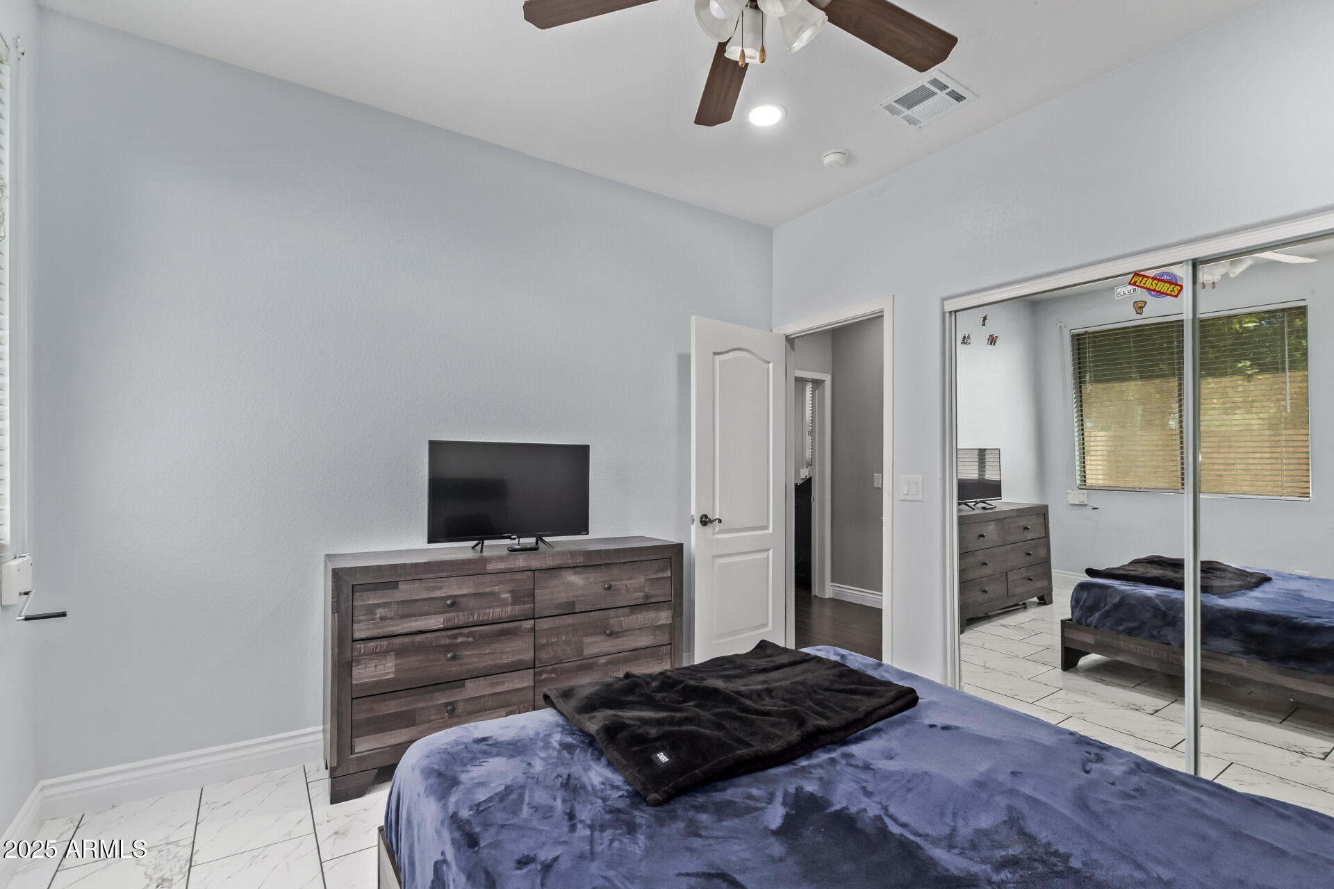 2225 West Carter Road Phoenix, AZ 85041 - Photo 23 of 33 a bedroom with a bed and a flat screen tv