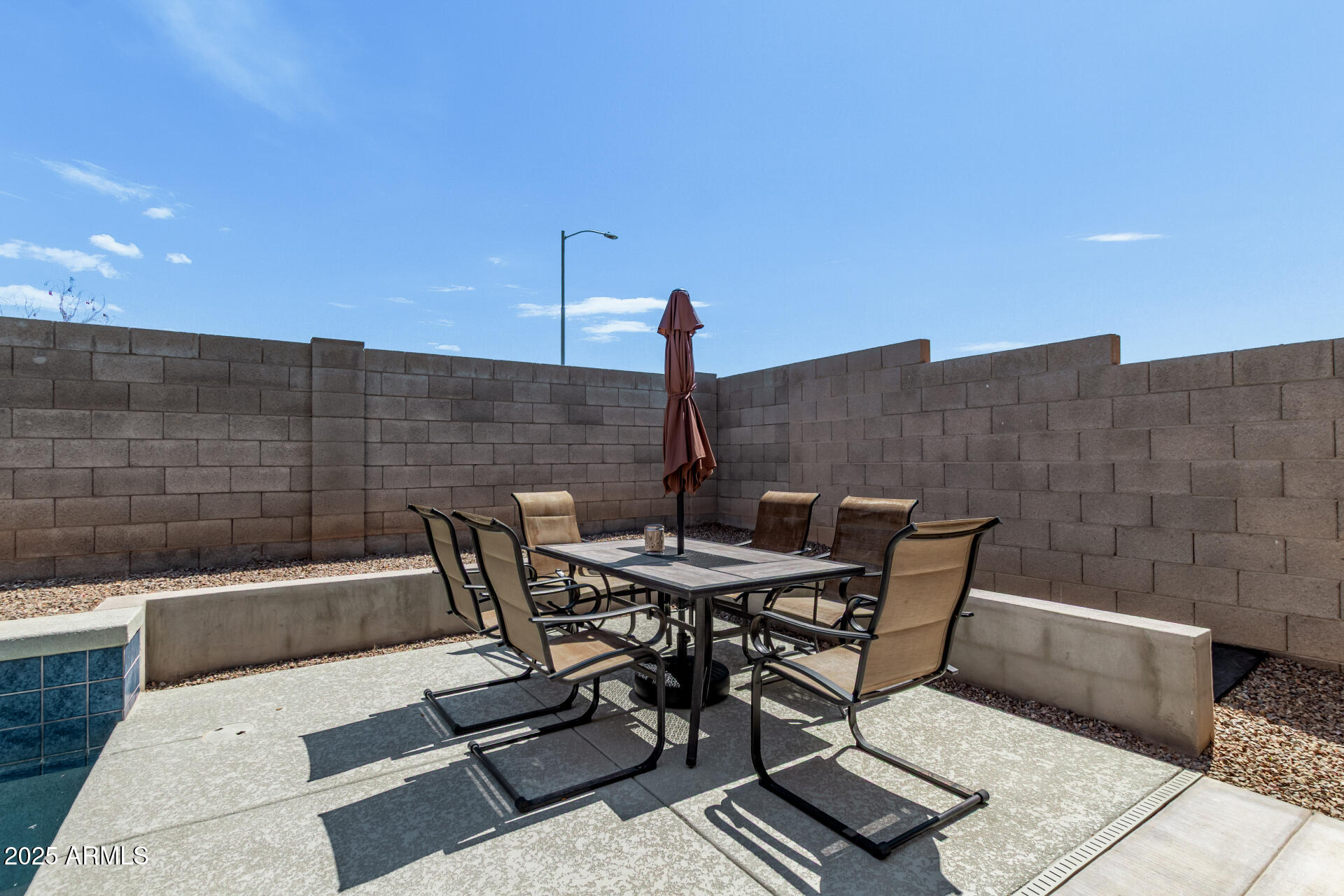 2225 West Carter Road Phoenix, AZ 85041 - Photo 31 of 33 a view of a terrace with a table and chairs