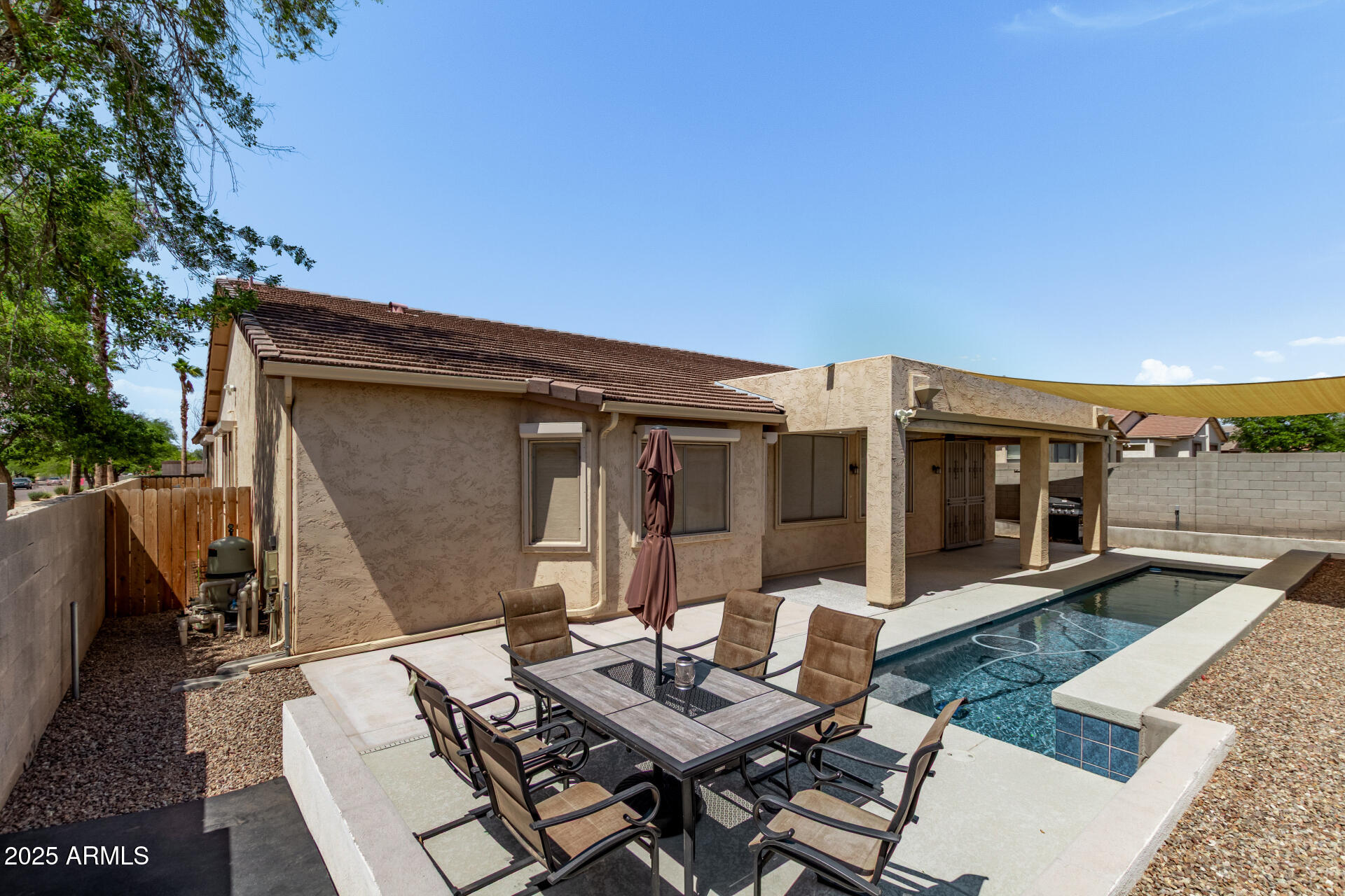 2225 West Carter Road Phoenix, AZ 85041 - Photo 32 of 33 a view of a patio with table and chairs with wooden floor and fence