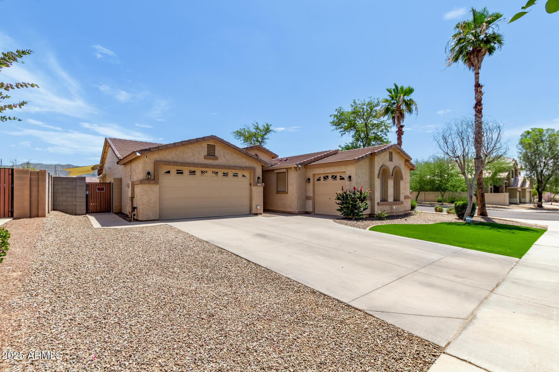 2225 West Carter Road Phoenix, AZ 85041 - Photo 4 of 33 a front view of a house with a yard and garage