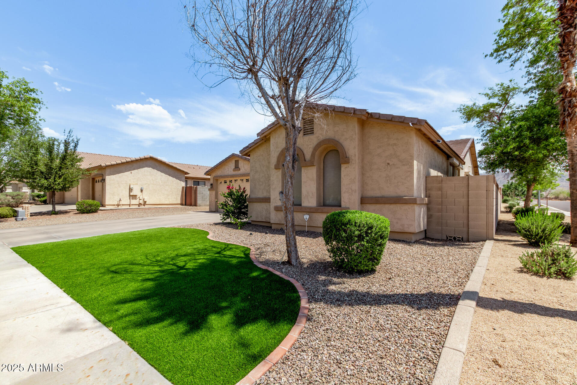2225 West Carter Road Phoenix, AZ 85041 - Photo 6 of 33 a front view of a house with garden